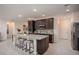 Large kitchen island with granite countertops and dark wood cabinets at 25503 Calusa Dr, Punta Gorda, FL 33955