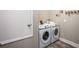 Functional laundry room with washer and dryer, and storage at 25503 Calusa Dr, Punta Gorda, FL 33955