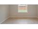 Empty spare bedroom with large window and tile floors at 25491 Calusa Dr, Punta Gorda, FL 33955