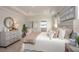 Bright bedroom featuring a king-size bed and neutral color palette at 25488 Calusa Dr, Punta Gorda, FL 33955