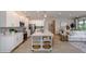 Open kitchen boasts white cabinets, large island, and stainless steel appliances at 25488 Calusa Dr, Punta Gorda, FL 33955