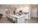 Modern kitchen with white cabinets, a large island, and quartz countertops at 25488 Calusa Dr, Punta Gorda, FL 33955