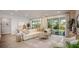 Bright living room with sliding glass doors and a neutral color palette at 25488 Calusa Dr, Punta Gorda, FL 33955