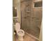 Walk-in shower with grab bars and tiled walls at 7234 Cedar Hollow Cir # 7234, Bradenton, FL 34203