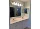 Double vanity bathroom with large mirror and bright lighting at 7234 Cedar Hollow Cir # 7234, Bradenton, FL 34203