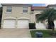 Two-story condo building with attached garages and palm trees at 7234 Cedar Hollow Cir # 7234, Bradenton, FL 34203