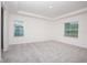 Spacious bedroom with neutral carpeting and two windows at 25388 Alicante Dr, Punta Gorda, FL 33955