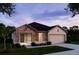 One-story house with stone accents and a two-car garage at 25533 Calusa Dr, Punta Gorda, FL 33955