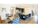 Bright dining area with glass table and blue patterned chairs at 3194 Cabo St, North Port, FL 34291