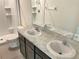 Modern bathroom with dual sinks, a shower, and a toilet at 530 Glenn Cross Dr, Ruskin, FL 33570