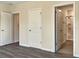 Bedroom with an open door to the bathroom and grey wood-look flooring at 530 Glenn Cross Dr, Ruskin, FL 33570