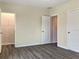 Simple bedroom with grey wood-look flooring and an open door to a closet at 530 Glenn Cross Dr, Ruskin, FL 33570