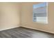 Simple bedroom with grey wood-look flooring and a window with blinds at 530 Glenn Cross Dr, Ruskin, FL 33570