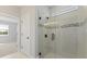 Modern bathroom with a large glass shower and neutral tile at 522 Sun Chaser Dr, Nokomis, FL 34275
