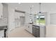 Modern kitchen with island, stainless steel appliances, and white cabinetry at 522 Sun Chaser Dr, Nokomis, FL 34275