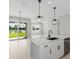 Bright kitchen features white cabinets, quartz countertops, and a view to the backyard at 522 Sun Chaser Dr, Nokomis, FL 34275