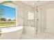 Spa-like bathroom with a freestanding tub, large shower, and marble tile at 17476 Vellum Cir, Punta Gorda, FL 33955