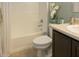 Clean bathroom featuring a shower/tub combo and dark brown vanity at 5637 Ocarina Rd, North Port, FL 34291