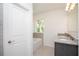 Bright bathroom featuring a granite double vanity, tub and window letting in plenty of natural light at 5637 Ocarina Rd, North Port, FL 34291