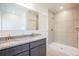 Modern bathroom featuring a double sink vanity and a tiled shower stall at 5637 Ocarina Rd, North Port, FL 34291