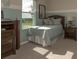 Bright bedroom with a comfortable bed, window, and neutral color scheme at 5637 Ocarina Rd, North Port, FL 34291