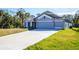 Inviting single-story home featuring a 3-car garage and a long driveway at 5637 Ocarina Rd, North Port, FL 34291