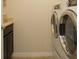 Convenient laundry room with washer and dryer, and extra counter space at 5637 Ocarina Rd, North Port, FL 34291