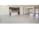 Open-concept living space with tile flooring connecting the living room to the kitchen at 5637 Ocarina Rd, North Port, FL 34291