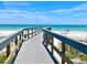 Walkway to the beach offering scenic ocean views at 9715 Harrell Ave # 40, Treasure Island, FL 33706