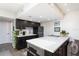Modern kitchen with dark cabinets and a large island at 9715 Harrell Ave # 40, Treasure Island, FL 33706