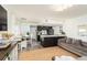 Open living room and kitchen with modern furniture and large windows at 9715 Harrell Ave # 40, Treasure Island, FL 33706