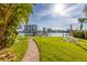 Brick pathway leads to waterfront with dock and seating at 9715 Harrell Ave # 40, Treasure Island, FL 33706