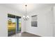 Dining area with a chandelier, sliding glass doors, and a view of the backyard at 1005 Signet, Apollo Beach, FL 33572