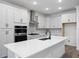 Modern kitchen featuring white cabinets, stainless steel appliances, and a large island at 1005 Signet, Apollo Beach, FL 33572