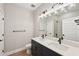 Modern bathroom with double vanity and dark blue cabinets at 494 Sun Chaser Dr, Nokomis, FL 34275