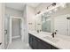 Modern bathroom with double vanity, quartz countertop, and a walk-in shower at 494 Sun Chaser Dr, Nokomis, FL 34275