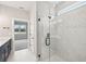 Bathroom with a walk-in shower, marble tile, and modern fixtures at 494 Sun Chaser Dr, Nokomis, FL 34275