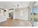 Dining room with hardwood floors and modern light fixture adjacent to kitchen at 494 Sun Chaser Dr, Nokomis, FL 34275