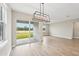 Bright dining room with sliding glass doors leading to the backyard at 494 Sun Chaser Dr, Nokomis, FL 34275