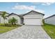 Single-story home with a paved driveway and landscaping at 494 Sun Chaser Dr, Nokomis, FL 34275