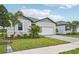 House exterior with a landscaped lawn, driveway, and garage at 494 Sun Chaser Dr, Nokomis, FL 34275