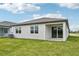 Single story house with covered patio and grassy backyard at 494 Sun Chaser Dr, Nokomis, FL 34275