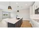 Modern kitchen island with white cabinets and quartz countertops at 494 Sun Chaser Dr, Nokomis, FL 34275