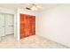 Spacious bedroom with wood closet doors and ceiling fan at 6165 Chesham Dr # 3, New Port Richey, FL 34653