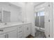 Bathroom with double vanity, white cabinets, and a walk-in shower at 17343 Peregrine Way, Punta Gorda, FL 33982