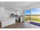 Modern kitchen with white cabinets, island, and view of backyard at 17343 Peregrine Way, Punta Gorda, FL 33982