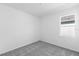 Bright and airy bedroom with gray carpet and a large window at 9576 Vibrant Lane, Venice, FL 34292