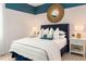 Bedroom with navy headboard and striped bedding at 9576 Vibrant Lane, Venice, FL 34292