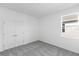 Neutral-toned bedroom with carpet, closet, and natural light from the window at 9576 Vibrant Lane, Venice, FL 34292