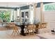 Dining room with a dark brown table and light wood chairs at 9576 Vibrant Lane, Venice, FL 34292